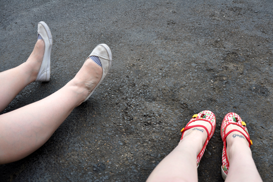 The feet of my travelling companion and I. Waiting for the bus to take us to Graceland. 